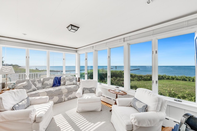 sunroom / solarium with a baseboard radiator and a water view
