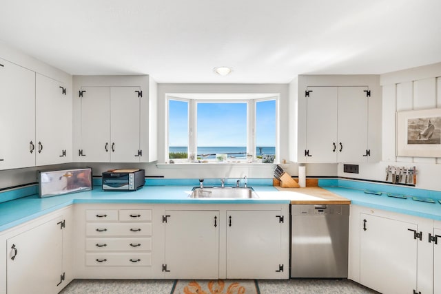 kitchen featuring light countertops, a sink, and stainless steel dishwasher