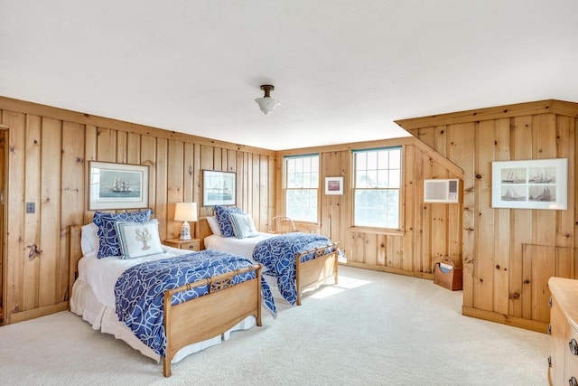 bedroom featuring wooden walls, carpet, a wall unit AC, and baseboards