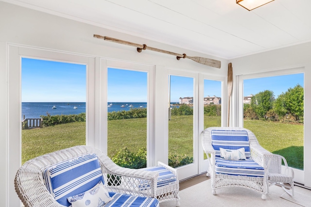 sunroom / solarium with a water view