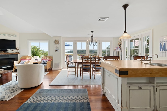 63 Briar Spring Rd, Orleans, MA 02653 - kitchen featuring healthy amount of natural light, dark wood-type flooring, and decorative light fixtures