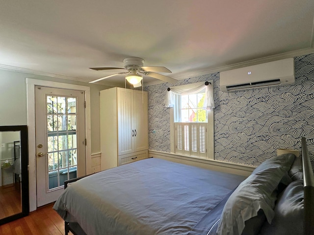 bedroom with crown molding, a ceiling fan, an AC wall unit, wood finished floors, and wallpapered walls