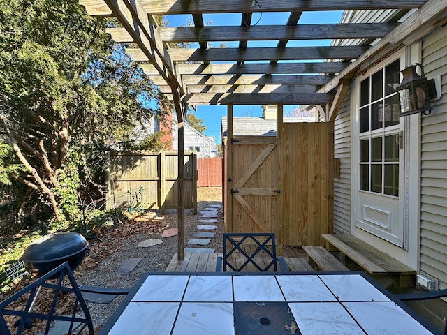 view of patio featuring fence, area for grilling, a pergola, and outdoor dining space