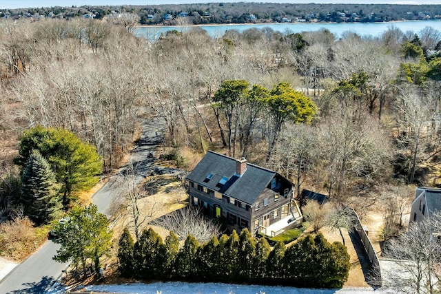 birds eye view of property featuring a view of trees