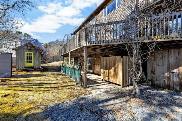 view of property exterior featuring a deck and an outbuilding