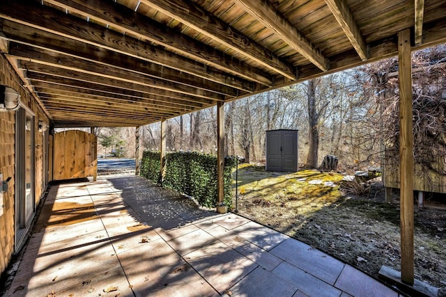 view of patio with an outbuilding and a storage unit