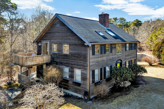 back of property with a chimney