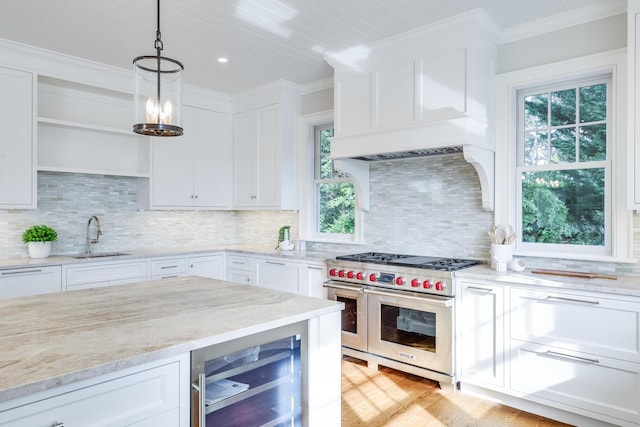 71 Towhee Ln, Orleans, MA 02653 - kitchen with range with two ovens, a healthy amount of sunlight, a sink, and wine cooler