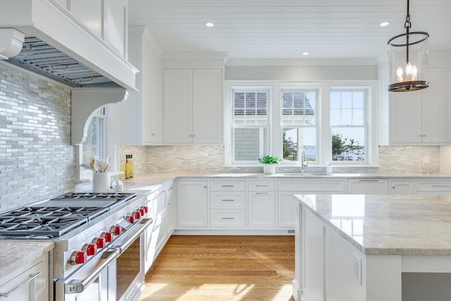 71 Towhee Ln, Orleans, MA 02653 - kitchen with a sink, premium range hood, high end stainless steel range oven, and white cabinetry
