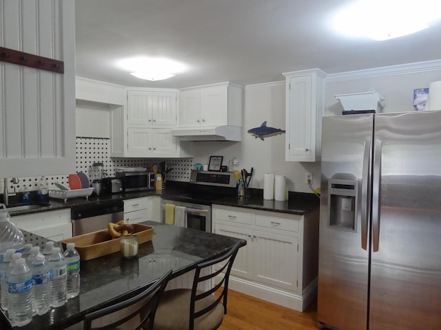 kitchen featuring sink, stainless steel appliances, white cabinetry, and light wood-type flooring