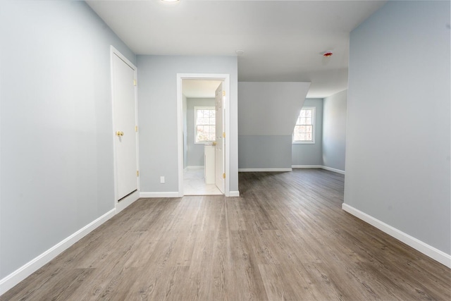 spare room featuring wood finished floors and baseboards