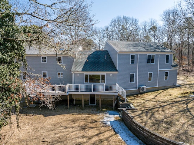 rear view of property featuring a yard and a wooden deck