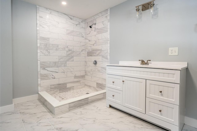 bathroom featuring marble finish floor, recessed lighting, a stall shower, vanity, and baseboards