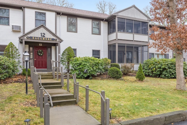 view of front of house featuring a front yard and a sunroom