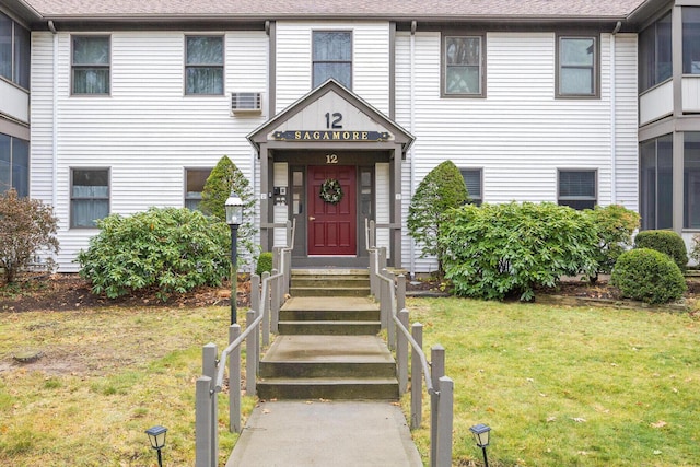 entrance to property featuring a lawn