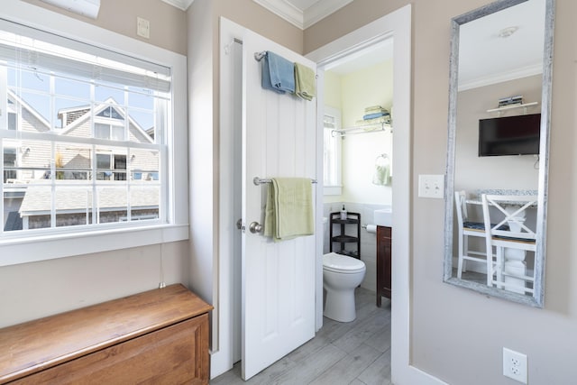 bathroom with crown molding and toilet