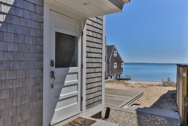 entrance to property featuring a water view and a view of the beach