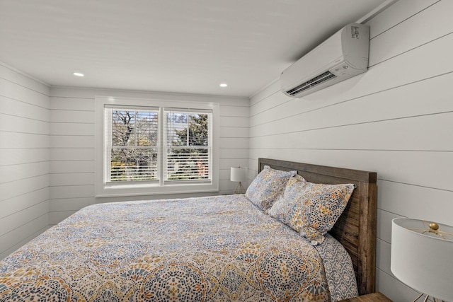 bedroom featuring wooden walls and a wall mounted air conditioner