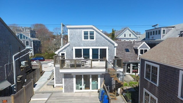 back of house featuring a balcony