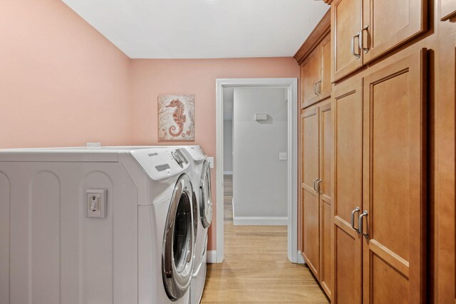 49 Heather Ln, Centerville, MA 02632 - washroom with light wood finished floors, baseboards, washing machine and clothes dryer, and cabinet space