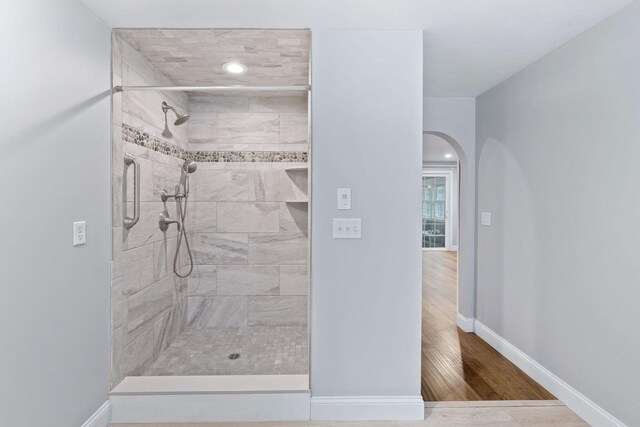 49 Heather Ln, Centerville, MA 02632 - bathroom featuring tiled shower, wood finished floors, and baseboards