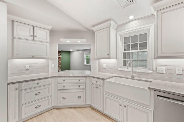 49 Heather Ln, Centerville, MA 02632 - kitchen featuring visible vents, dishwasher, a sink, light wood-style flooring, and lofted ceiling