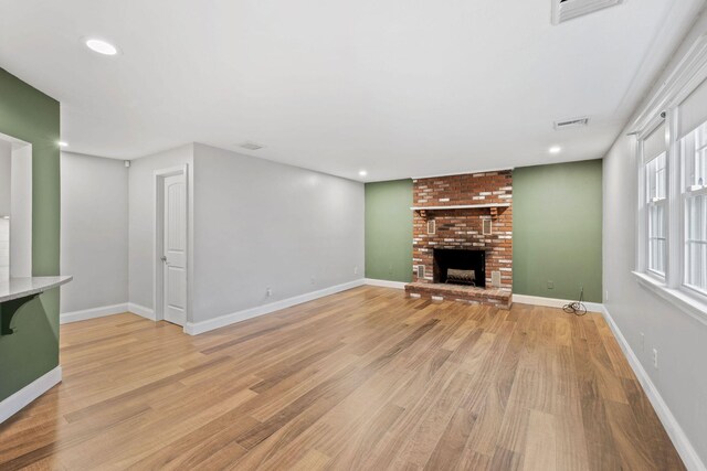 49 Heather Ln, Centerville, MA 02632 - unfurnished living room featuring visible vents, baseboards, a brick fireplace, light wood finished floors, and recessed lighting