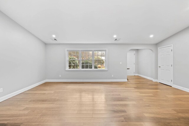 49 Heather Ln, Centerville, MA 02632 - unfurnished living room with light wood-type flooring, baseboards, recessed lighting, visible vents, and arched walkways