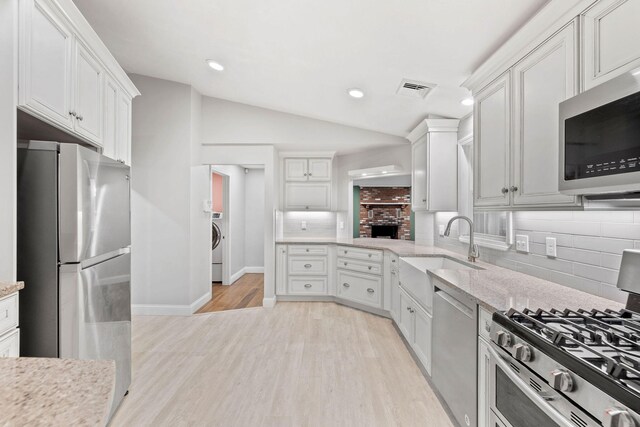 49 Heather Ln, Centerville, MA 02632 - kitchen featuring light wood-type flooring, white cabinets, visible vents, appliances with stainless steel finishes, and a sink