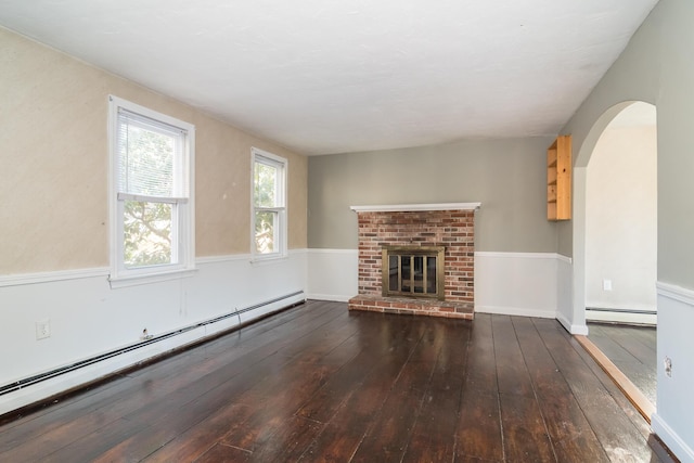 62 Windsor Rd, Sandwich, MA 02563 - unfurnished living room with a baseboard heating unit, dark wood-type flooring, and a brick fireplace