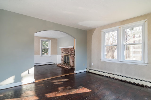 62 Windsor Rd, Sandwich, MA 02563 - unfurnished living room with a brick fireplace, dark hardwood / wood-style floors, and baseboard heating