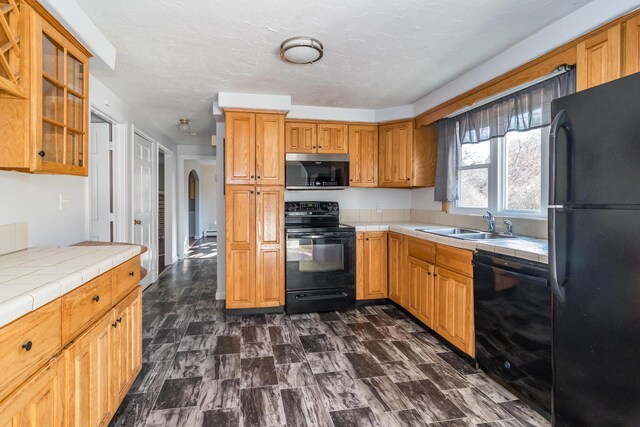 62 Windsor Rd, Sandwich, MA 02563 - kitchen with sink, tile countertops, a textured ceiling, and black appliances