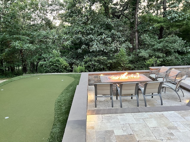 66 Frog Pond Close, Mashpee, MA 02649 - view of patio featuring an outdoor fire pit, a putting area, and view of scattered trees
