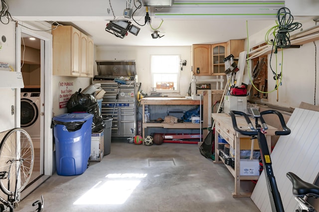 garage featuring washer / dryer and a workshop area