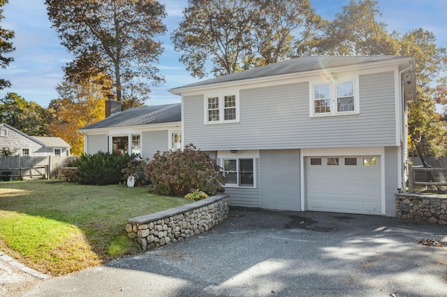 view of front of property with a garage and a front yard