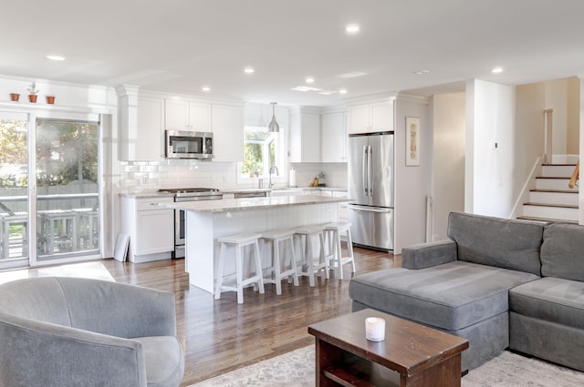 living room featuring sink and hardwood / wood-style floors