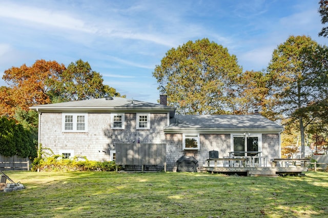 back of house with a wooden deck and a yard