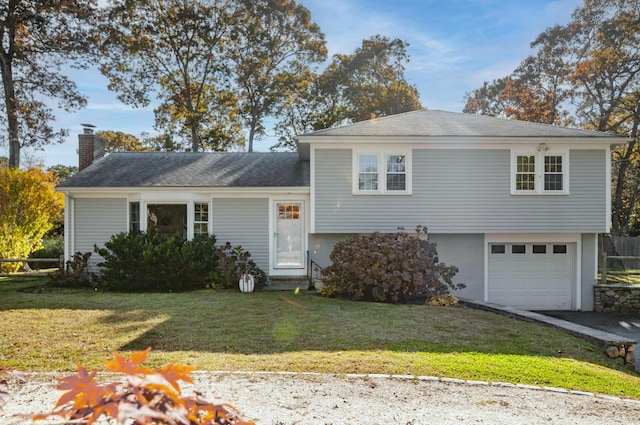 view of front facade with a garage and a front lawn