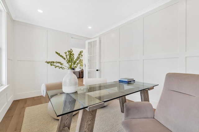 interior space featuring a decorative wall, light wood-style flooring, french doors, and recessed lighting