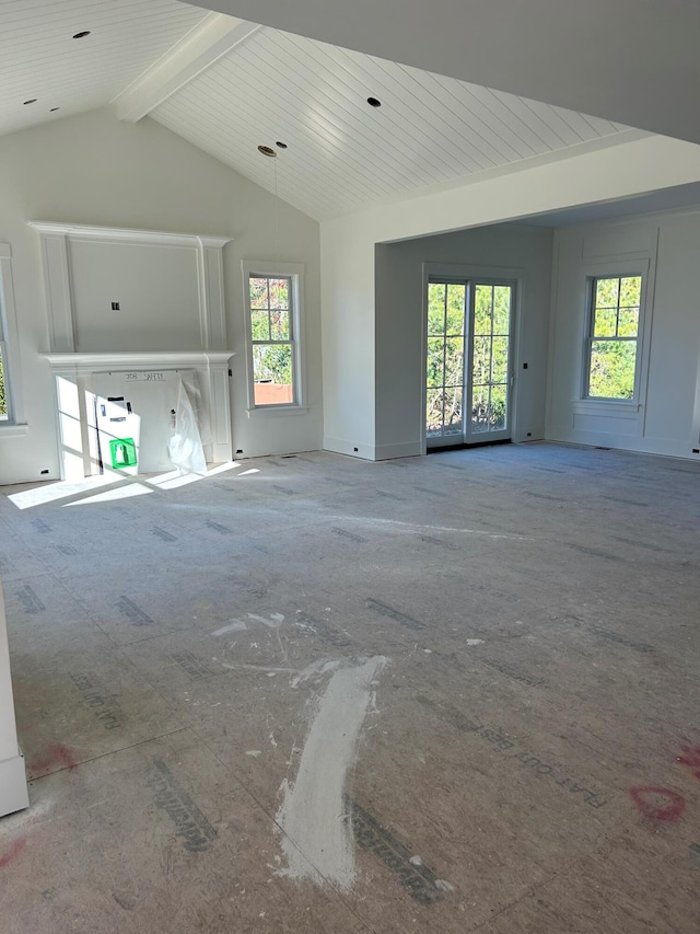 unfurnished living room featuring beam ceiling and high vaulted ceiling