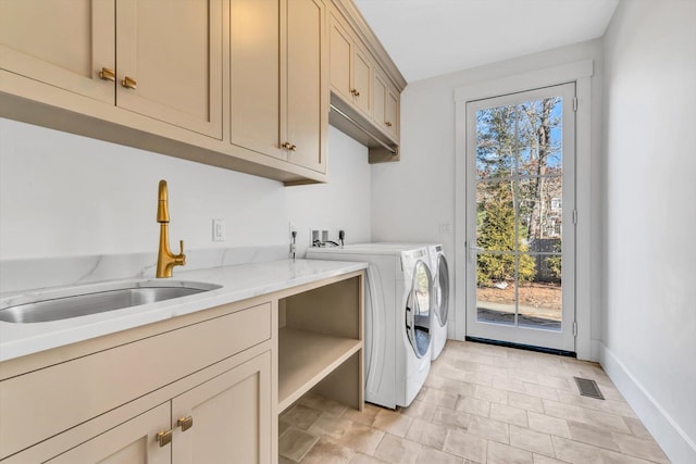 laundry area with washer and clothes dryer, a wealth of natural light, a sink, visible vents, and cabinet space