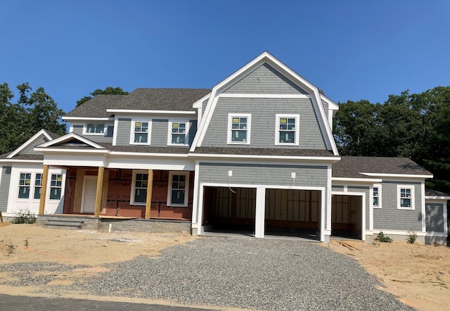 view of front of property with covered porch and a garage