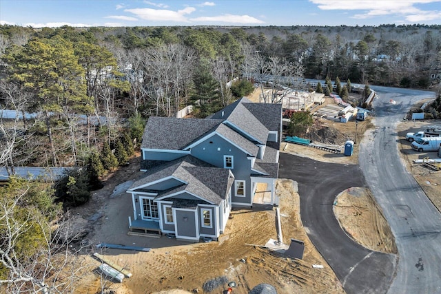 drone / aerial view featuring a wooded view