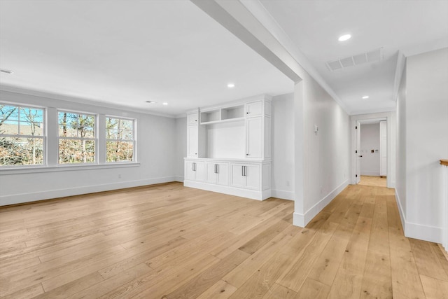 unfurnished living room featuring baseboards, visible vents, light wood-style floors, and recessed lighting
