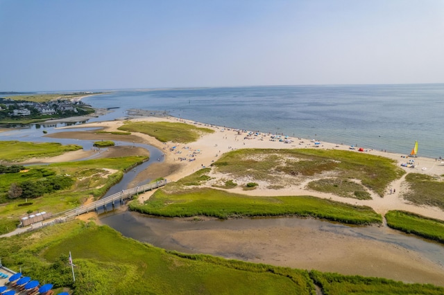 birds eye view of property with a water view and a beach view