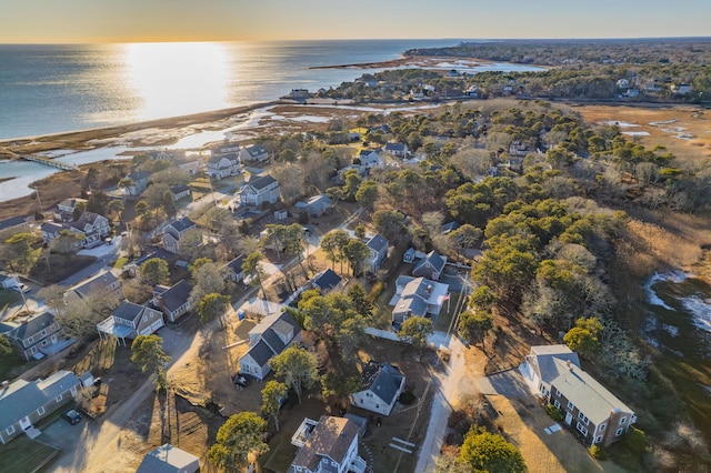 aerial view at dusk featuring a water view