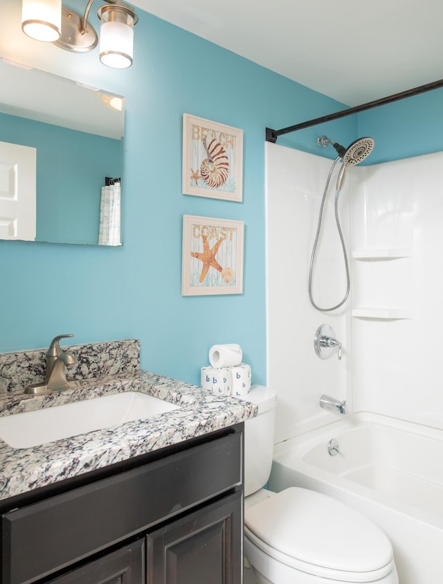 full bathroom featuring shower / washtub combination, toilet, and vanity