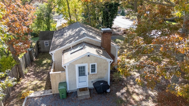 back of property featuring a shed