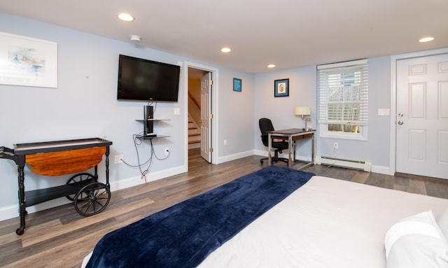 bedroom with dark hardwood / wood-style floors and a baseboard radiator