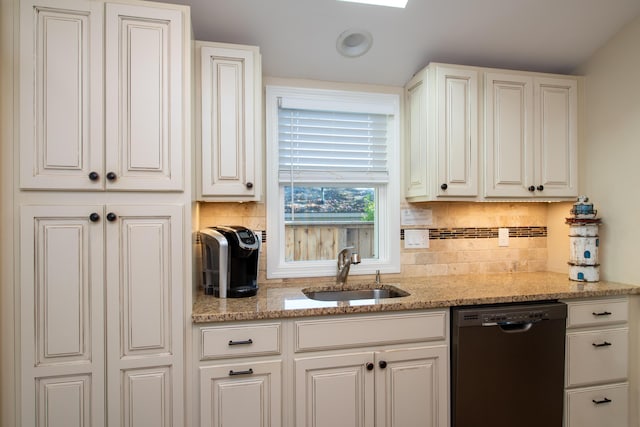 kitchen featuring light stone counters, sink, white cabinets, and dishwasher